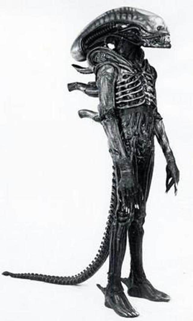 “No wonder Giger’s art worked its eldritch spell on Scott during the pre-production of Alien. Once the director peeked inside the artist’s 1977 compendium Necronomicon, the images stuck in his mind like an alien larva. Named for the Book of the Dead from HP Lovecraft’s fiction, Necronomicon contained among others two lithographs of an oblong-headed being that became the basis for the xenomorph. ” (Photographer Mike Sibthorp, artist; H.R Giger/Wikimedia Commons) “No wonder Giger’s art worked its eldritch spell on Scott during the pre-production of Alien. Once the director peeked inside the artist’s 1977 compendium Necronomicon, the images stuck in his mind like an alien larva. Named for the Book of the Dead from HP Lovecraft’s fiction, Necronomicon contained among others two lithographs of an oblong-headed being that became the basis for the xenomorph. ” (Photographer Mike Sibthorp, artist; H.R Giger/Wikimedia Commons)