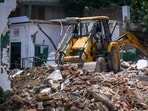 A bulldozer demolishing a structure in Delhi.