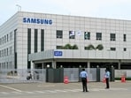 Security personnel stand guard at Samsung India's plant in Sriperumbudur, near Chennai on September 11, 2024, as workers stage a protest to demand higher wages and recognition of their union. (R.Satish Babu/AFP) Security personnel stand guard at Samsung India's plant in Sriperumbudur, near Chennai on September 11, 2024, as workers stage a protest to demand higher wages and recognition of their union. (R.Satish Babu/AFP)