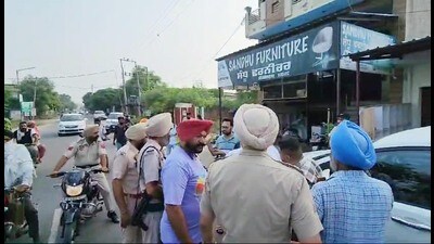 Police personnel and local residents outside a shop of Pargat Singh, uncle of jailed Khadoor Sahib MP Amritpal Singh, during the NIA raid in Rayya , Amritsar, on Friday. (HT photo) Police personnel and local residents outside a shop of Pargat Singh, uncle of jailed Khadoor Sahib MP Amritpal Singh, during the NIA raid in Rayya , Amritsar, on Friday. (HT photo)