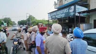 Police personnel and local residents outside the furniture shop of Pargat Singh Sandhu, an uncle of jailed Khadoor Sahib MP Amritpal Singh, during NIA raid at Rayya in Amritsar district on Friday. (HT Photo) Police personnel and local residents outside the furniture shop of Pargat Singh Sandhu, an uncle of jailed Khadoor Sahib MP Amritpal Singh, during NIA raid at Rayya in Amritsar district on Friday. (HT Photo)