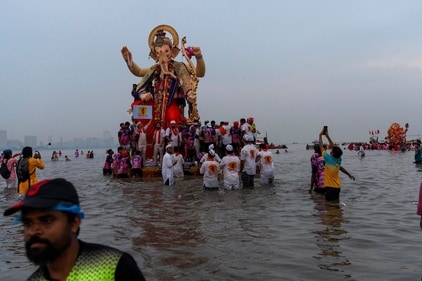Devotees immerse an idol of Ganpati Bappa on Ganesh Visarjan. (AP) Devotees immerse an idol of Ganpati Bappa on Ganesh Visarjan. (AP)