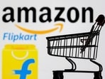 Small toy shopping cart is seen in front of displayed Amazon and Flipkart logos in this picture illustration taken, July 30, 2021 
