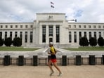 FILE PHOTO: A jogger runs past the Federal Reserve building in Washington, DC, U.S., August 22, 2018. REUTERS/Chris Wattie/File Photo