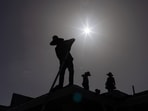 Roofers sport hats to take cover from the sun during a heatwave in Eagle Pass, Texas, U.S. July 27, 2023.  REUTERS/Adrees Latif     TPX IMAGES OF THE DAY