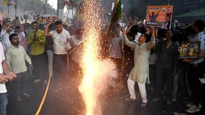 AAP supporters burst firecrackers outside the party office in New Delhi on Friday. (ANI) AAP supporters burst firecrackers outside the party office in New Delhi on Friday. (ANI)