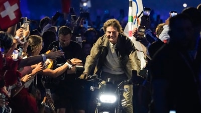 Tom Cruise rides a motorbike with the Olympic flag attached during the 2024 Summer Olympics closing ceremony at the Stade de France, Sunday, Aug. 11, 2024, in Saint-Denis, France. AP/PTI(AP08_12_2024_000073B) (AP) Tom Cruise rides a motorbike with the Olympic flag attached during the 2024 Summer Olympics closing ceremony at the Stade de France, Sunday, Aug. 11, 2024, in Saint-Denis, France. AP/PTI(AP08_12_2024_000073B) (AP)