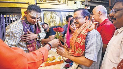 Chief Minister Arvind Kejriwal with his wife Sunita Kejriwal and former deputy CM Manish Sisodia at the Hanuman Temple in Connaught Place, in New Delhi on Saturday. (RAJ K RAJ /HT PHOTO) Chief Minister Arvind Kejriwal with his wife Sunita Kejriwal and former deputy CM Manish Sisodia at the Hanuman Temple in Connaught Place, in New Delhi on Saturday. (RAJ K RAJ /HT PHOTO)