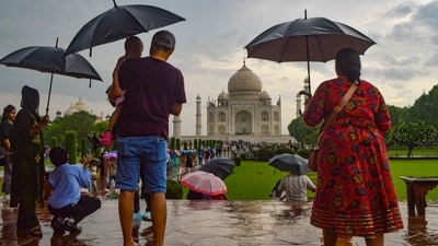Visitors use umbrellas to shield themselves during rains, at the Taj Mahal in Agra. (PTI file) Visitors use umbrellas to shield themselves during rains, at the Taj Mahal in Agra. (PTI file)