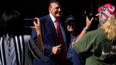 Laura Loomer, at left, takes a photo as Republican presidential nominee former President Donald Trump visits the Shanksville Volunteer Fire Company in Shanksville, Pa., Wednesday, Sept. 11, 2024. (AP Photo/Matt Rourke) (AP) Laura Loomer, at left, takes a photo as Republican presidential nominee former President Donald Trump visits the Shanksville Volunteer Fire Company in Shanksville, Pa., Wednesday, Sept. 11, 2024. (AP Photo/Matt Rourke) (AP)