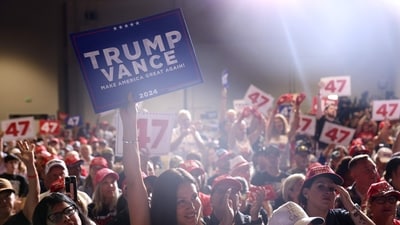 LAS VEGAS, NEVADA - SEPTEMBER 13: Supporters of Republican presidential nominee, former U.S. President Donald Trump, hold signs during a campaign rally at The Expo at World Market Center Las Vegas on September 13, 2024 in Las Vegas, Nevada. With 53 days before election day, Former President Trump continues to campaign. Justin Sullivan/Getty Images/AFP (Photo by JUSTIN SULLIVAN / GETTY IMAGES NORTH AMERICA / Getty Images via AFP) (Getty Images via AFP) LAS VEGAS, NEVADA - SEPTEMBER 13: Supporters of Republican presidential nominee, former U.S. President Donald Trump, hold signs during a campaign rally at The Expo at World Market Center Las Vegas on September 13, 2024 in Las Vegas, Nevada. With 53 days before election day, Former President Trump continues to campaign. Justin Sullivan/Getty Images/AFP (Photo by JUSTIN SULLIVAN / GETTY IMAGES NORTH AMERICA / Getty Images via AFP) (Getty Images via AFP)