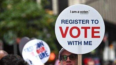 NEW YORK, NEW YORK - SEPTEMBER 06: An attendee holds a "Register to Vote" sign at Fashion For Our Future March on September 06, 2024 in Herald Square, New York City. Steven Ferdman/Getty Images/AFP (Photo by Steven Ferdman / GETTY IMAGES NORTH AMERICA / Getty Images via AFP) (Getty Images via AFP) NEW YORK, NEW YORK - SEPTEMBER 06: An attendee holds a "Register to Vote" sign at Fashion For Our Future March on September 06, 2024 in Herald Square, New York City. Steven Ferdman/Getty Images/AFP (Photo by Steven Ferdman / GETTY IMAGES NORTH AMERICA / Getty Images via AFP) (Getty Images via AFP)