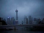  People walk with umbrellas on a bridge amid rains and winds brought by Typhoon Muifa, in Shanghai, China. China: Flights cancelled, cities evacuated, Mid-Autumn Festival travel disrupted as Typhoon Bebinca wreaks havoc 