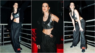 Shanaya Kapoor nailed a dapper look, rocking a Puma bralette with silver shimmer accents. She paired it with black baggy pants and a matching jacket, elevating the outfit with trendy sneakers and chunky silver jewellery. (Instagram) Shanaya Kapoor nailed a dapper look, rocking a Puma bralette with silver shimmer accents. She paired it with black baggy pants and a matching jacket, elevating the outfit with trendy sneakers and chunky silver jewellery. (Instagram)
