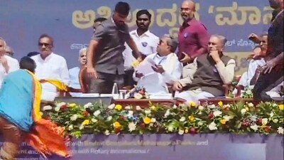 Security breach at International Day of Democracy event as an unidentified person approaches Karnataka Chief Minister Siddaramaiah's chair, in Bengaluru. (PTI) Security breach at International Day of Democracy event as an unidentified person approaches Karnataka Chief Minister Siddaramaiah's chair, in Bengaluru. (PTI)