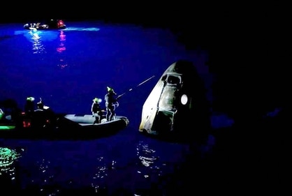 TOPSHOT - This still image taken from a SpaceX and Polaris broadcast on September 15, 2024, shows staff members approching the manned Polaris Dawn mission's "Dragon" capsule after it splashed down off the coast of Dry Tortugas, Florida, completing the first human spaceflight mission by non-government astronauts of the Polaris Program. The SpaceX Polaris Dawn mission, which made history when its crew conducted the first spacewalk by non-government astronauts, splashed down off the coast of Florida early on September 15, 2024. The Dragon spacecraft landed in the ocean at 3:37 am (0737 GMT), a webcast of the splashdown showed, with a recovery team deploying in the pre-dawn darkness to retrieve the capsule and crew. The capsule was lifted from the water and onto the recovery vessel half a hour later. (Photo by Polaris Program / AFP) / XGTY / RESTRICTED TO EDITORIAL USE - MANDATORY CREDIT "AFP PHOTO / SpaceX / Polaris" - NO MARKETING NO ADVERTISING CAMPAIGNS - DISTRIBUTED AS A SERVICE TO CLIENTS (AFP) TOPSHOT - This still image taken from a SpaceX and Polaris broadcast on September 15, 2024, shows staff members approching the manned Polaris Dawn mission's "Dragon" capsule after it splashed down off the coast of Dry Tortugas, Florida, completing the first human spaceflight mission by non-government astronauts of the Polaris Program. The SpaceX Polaris Dawn mission, which made history when its crew conducted the first spacewalk by non-government astronauts, splashed down off the coast of Florida early on September 15, 2024. The Dragon spacecraft landed in the ocean at 3:37 am (0737 GMT), a webcast of the splashdown showed, with a recovery team deploying in the pre-dawn darkness to retrieve the capsule and crew. The capsule was lifted from the water and onto the recovery vessel half a hour later. (Photo by Polaris Program / AFP) / XGTY / RESTRICTED TO EDITORIAL USE - MANDATORY CREDIT "AFP PHOTO / SpaceX / Polaris" - NO MARKETING NO ADVERTISING CAMPAIGNS - DISTRIBUTED AS A SERVICE TO CLIENTS (AFP)