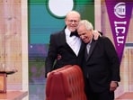 Presenters Ron Howard and Henry Winkler embrace in a set on stage at the 76th Primetime Emmy Awards.
