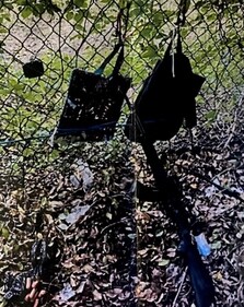 Bags hang from a fence over a rifle propped against it, after the Secret Service foiled what the FBI called an apparent assassination attempt on Republican presidential nominee and former U.S. President Donald Trump while he was golfing on his course in West Palm Beach, Florida, U.S. September 15, 2024. (via REUTERS)