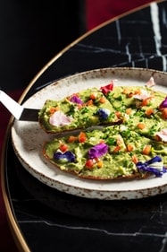 At Akina, guacamole is served on a crispy thin pizza base