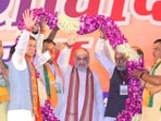 Union home minister Amit Shah acknowledges supporters at an election rally in Haryana's Loharu. Union home minister Amit Shah acknowledges supporters at an election rally in Haryana's Loharu.