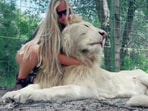 A viral video showed a woman cuddling a massive white lion, sparking a debate.