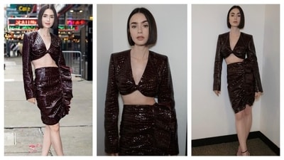 Lily Collins donned a two-piece set that featured a top with a deep v-neckline and long sleeves. Her knee-length skirt had ruffles and the entire outfit had a crocodile leather-like finish. She finished the look with black strappy heels and didn't opt for any accessories. (Instagram/@lilyjcollins) Lily Collins donned a two-piece set that featured a top with a deep v-neckline and long sleeves. Her knee-length skirt had ruffles and the entire outfit had a crocodile leather-like finish. She finished the look with black strappy heels and didn't opt for any accessories. (Instagram/@lilyjcollins)