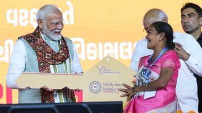 Ahmedabad: Prime Minister Narendra Modi hands over symbolic key to a beneficiary of Pradhan Mantri Aavas Yojna during Viksit Bharat Viksit Gujarat rally, in Ahmedabad, on Monday. (PTI) Ahmedabad: Prime Minister Narendra Modi hands over symbolic key to a beneficiary of Pradhan Mantri Aavas Yojna during Viksit Bharat Viksit Gujarat rally, in Ahmedabad, on Monday. (PTI)