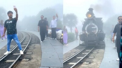 The man was seen standing in front of the toy train, trying to take a selfie. The man was seen standing in front of the toy train, trying to take a selfie.