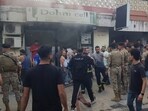 Lebanese soldiers and firefighters gather outside a mobile shop after what is believed to be the result of a walkie-talkie exploding inside it, in the southern port city of Sidon, Lebanon, Wednesday, Sept. 18, 2024. Lebanese soldiers and firefighters gather outside a mobile shop after what is believed to be the result of a walkie-talkie exploding inside it, in the southern port city of Sidon, Lebanon, Wednesday, Sept. 18, 2024.