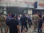 Lebanese soldiers and firefighters gather outside a mobile shop after what is believed to be the result of a walkie-talkie exploding inside it, in the southern port city of Sidon, Lebanon, Wednesday, Sept. 18, 2024. Lebanese soldiers and firefighters gather outside a mobile shop after what is believed to be the result of a walkie-talkie exploding inside it, in the southern port city of Sidon, Lebanon, Wednesday, Sept. 18, 2024.