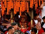 Living God Ganesh Rodin Shakya is presented in front of the crowd while being carried into his chariot during the annual Indra Jatra festival to worship Indra, Kumari and other deities and to mark the end of monsoon season in Kathmandu, Nepal.