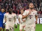 Bayern Munich's Harry Kane celebrates scoring their fourth goal with Alphonso Davies