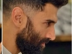 In a white T-shirt with his hands joined in front of him, Aditya can be seen posing for the pictures. 