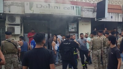 Lebanese soldiers and firefighters gather outside a mobile shop after what is believed to be the result of a walkie-talkie exploding inside it, in the southern port city of Sidon, Lebanon, Wednesday, Sept. 18, 2024. (AP) Lebanese soldiers and firefighters gather outside a mobile shop after what is believed to be the result of a walkie-talkie exploding inside it, in the southern port city of Sidon, Lebanon, Wednesday, Sept. 18, 2024. (AP)