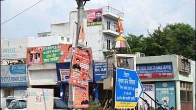 Posters of candidates preparing to contest the assembly elections hang on an electricity pole at Patel Nagar. (Parveen Kumar/HT Photo)
