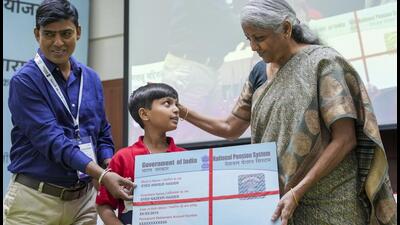 Union finance minister Nirmala Sitharaman with a child during the launch of NPS Vatsalya Scheme, in New Delhi, Wednesday (PTI) Union finance minister Nirmala Sitharaman with a child during the launch of NPS Vatsalya Scheme, in New Delhi, Wednesday (PTI)