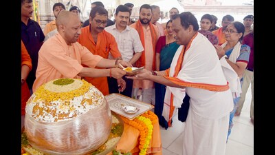 Uttar Pradesh Chief Minister Yogi Adityanath distributes sweets on the occasion of Prime Minister Narendra Modi's 74th birthday, at Kashi Vishwanath Temple in Varanasi on Tuesday. (ANI) Uttar Pradesh Chief Minister Yogi Adityanath distributes sweets on the occasion of Prime Minister Narendra Modi's 74th birthday, at Kashi Vishwanath Temple in Varanasi on Tuesday. (ANI)