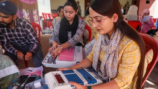 Polling officials check EVMs and other election material for the 1st phase of Jammu and Kashmir Assembly elections, in Kishtwar district of Jammu and Kashmir on Tuesday. (PTI)