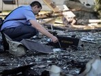 FILE PHOTO: A war crimes prosecutor works at a site of a Russian drone attack, amid Russia's attack on Ukraine, on the outskirts of Lviv, Ukraine June 19, 2024. REUTERS/Roman Baluk/File Photo