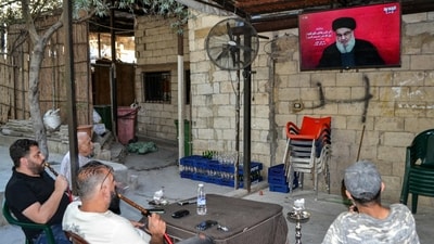 Men smoke waterpipes as they attend a televised speech by the leader of the Lebanese Shiite movement Hezbollah Hassan Nasrallah at a cafe in the Jabal Mehsen neighbourhood of Lebanon's northern city of Tripoli. (Photo by Fathi AL-MASRI / AFP) (AFP) Men smoke waterpipes as they attend a televised speech by the leader of the Lebanese Shiite movement Hezbollah Hassan Nasrallah at a cafe in the Jabal Mehsen neighbourhood of Lebanon's northern city of Tripoli. (Photo by Fathi AL-MASRI / AFP) (AFP)