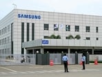 Security personnel stand guard at Samsung India's plant in Sriperumbudur, near Chennai on September 11, 2024, as workers stage a protest to demand higher wages and recognition of their union. Security personnel stand guard at Samsung India's plant in Sriperumbudur, near Chennai on September 11, 2024, as workers stage a protest to demand higher wages and recognition of their union.