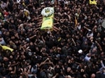 Mourners gather at the funeral of Hezbollah members Fadel Abbas Bazzi and Ahmad Ali Hassan after hand-held radios and pagers used by armed group Hezbollah detonated across Lebanon on September 19.