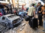 People gather in front of a building targeted by an Israeli strike in Beirut's southern suburbs on September 20, 2024. The strike on Hezbollah's stronghold in Lebanon's capital Beirut reportedly killed at least eight people and wounded dozens of others, with a source close to the movement saying a top military leader was dead. (Photo by AFP)