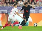 Barcelona's Lamine Yamal, right, is challenged by Monaco's Vanderson during the Champions League 