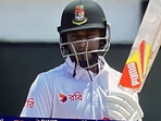 Shakib Al Hasan bats with a string attached to helmet