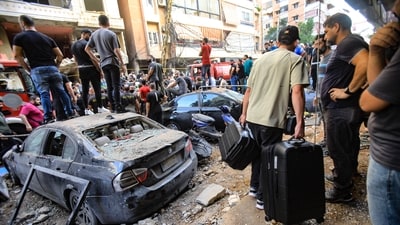 People gather in front of a building targeted by an Israeli strike in Beirut's southern suburbs on September 20, 2024. The strike on Hezbollah's stronghold in Lebanon's capital Beirut reportedly killed at least eight people and wounded dozens of others, with a source close to the movement saying a top military leader was dead. (Photo by AFP) (AFP) People gather in front of a building targeted by an Israeli strike in Beirut's southern suburbs on September 20, 2024. The strike on Hezbollah's stronghold in Lebanon's capital Beirut reportedly killed at least eight people and wounded dozens of others, with a source close to the movement saying a top military leader was dead. (Photo by AFP) (AFP)