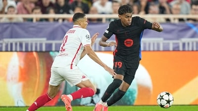 Barcelona's Lamine Yamal, right, is challenged by Monaco's Vanderson during the Champions League (AP)