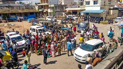 Police try to remove people who were blocking a road following clashes between two groups allegedly during a Ganpati procession, Nagamangala town of Karnataka's Mandya district. (PTI) Police try to remove people who were blocking a road following clashes between two groups allegedly during a Ganpati procession, Nagamangala town of Karnataka's Mandya district. (PTI)