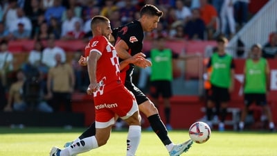 Barcelona's Robert Lewandowski, right, challenges for the ball with Girona's David Lopez. (AP) Barcelona's Robert Lewandowski, right, challenges for the ball with Girona's David Lopez. (AP)