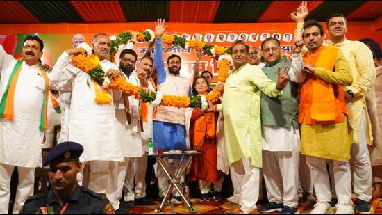 CM Nayab Singh Saini with BJP candidate from Kalka Shakti Rani Sharma and others during a rally in Raipur Rani, Panchkula, on Friday. (HT Photo)